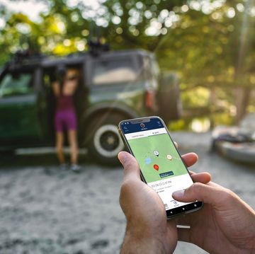 ford bronco trail app used in front of bronco in eruption green